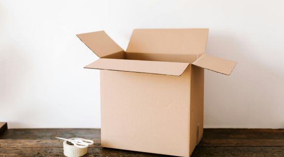 Empty cardboard shipping box sized for diabetic test strip cartons
